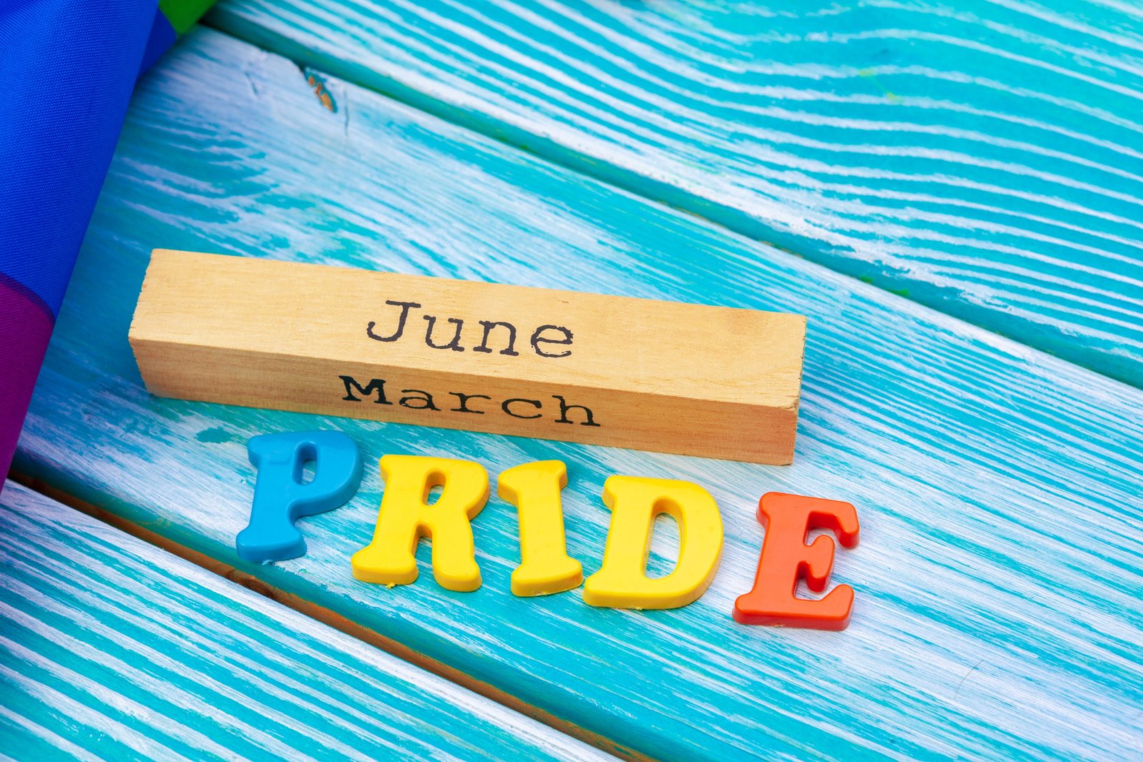 Gay pride flag on wooden table